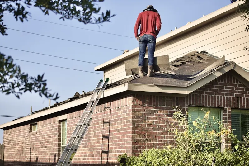 Professional roofer working on a residential roof in Kewanna